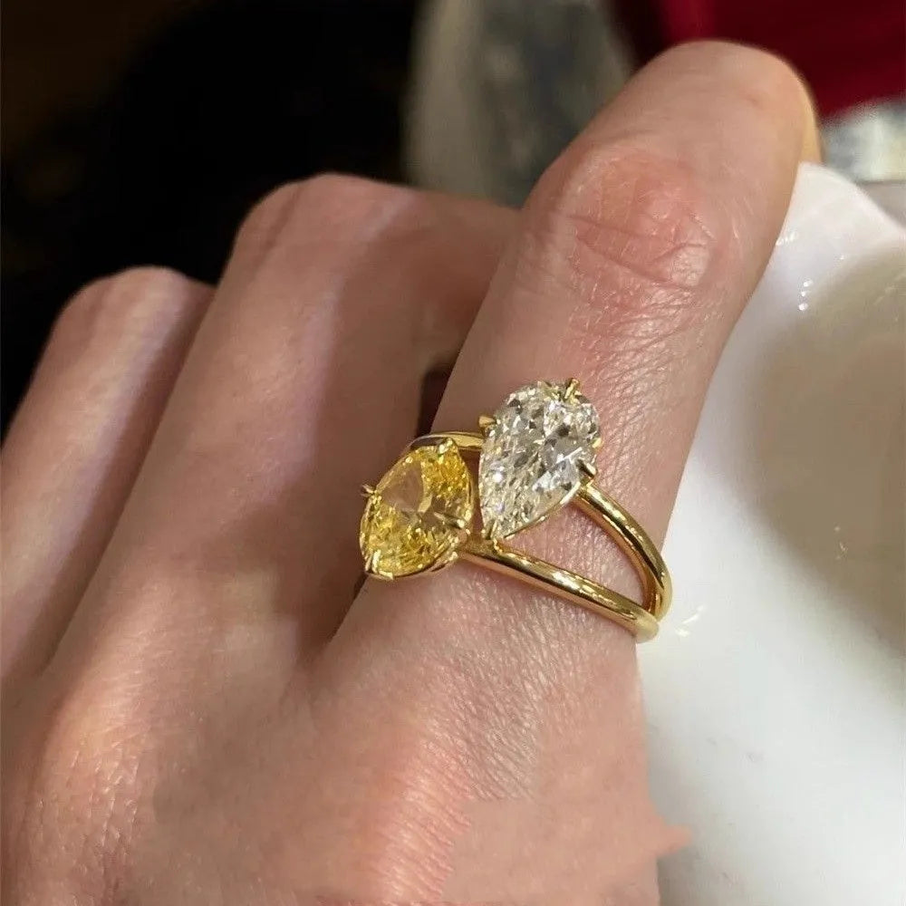 Open geometric ring with water drop shaped zircon stones in contrasting colours