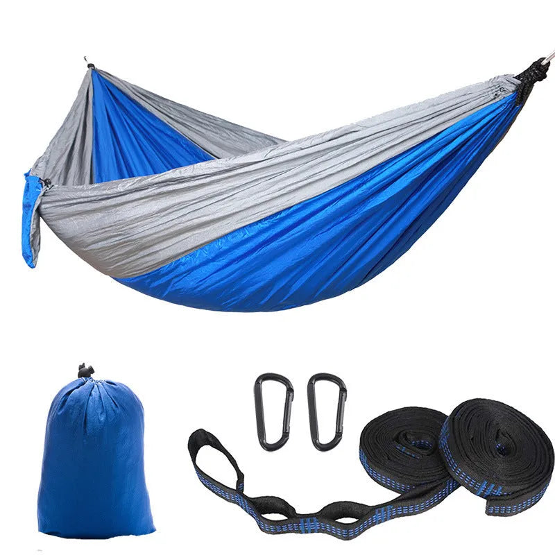 Double camping hammock with ropes and buckles shown in outdoor setting