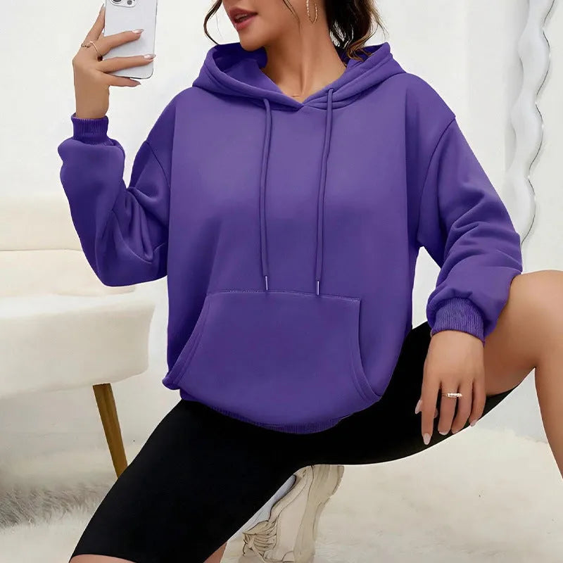 Women's loose fit grey sweatshirt with front drawstring detail and long sleeves on a hanger