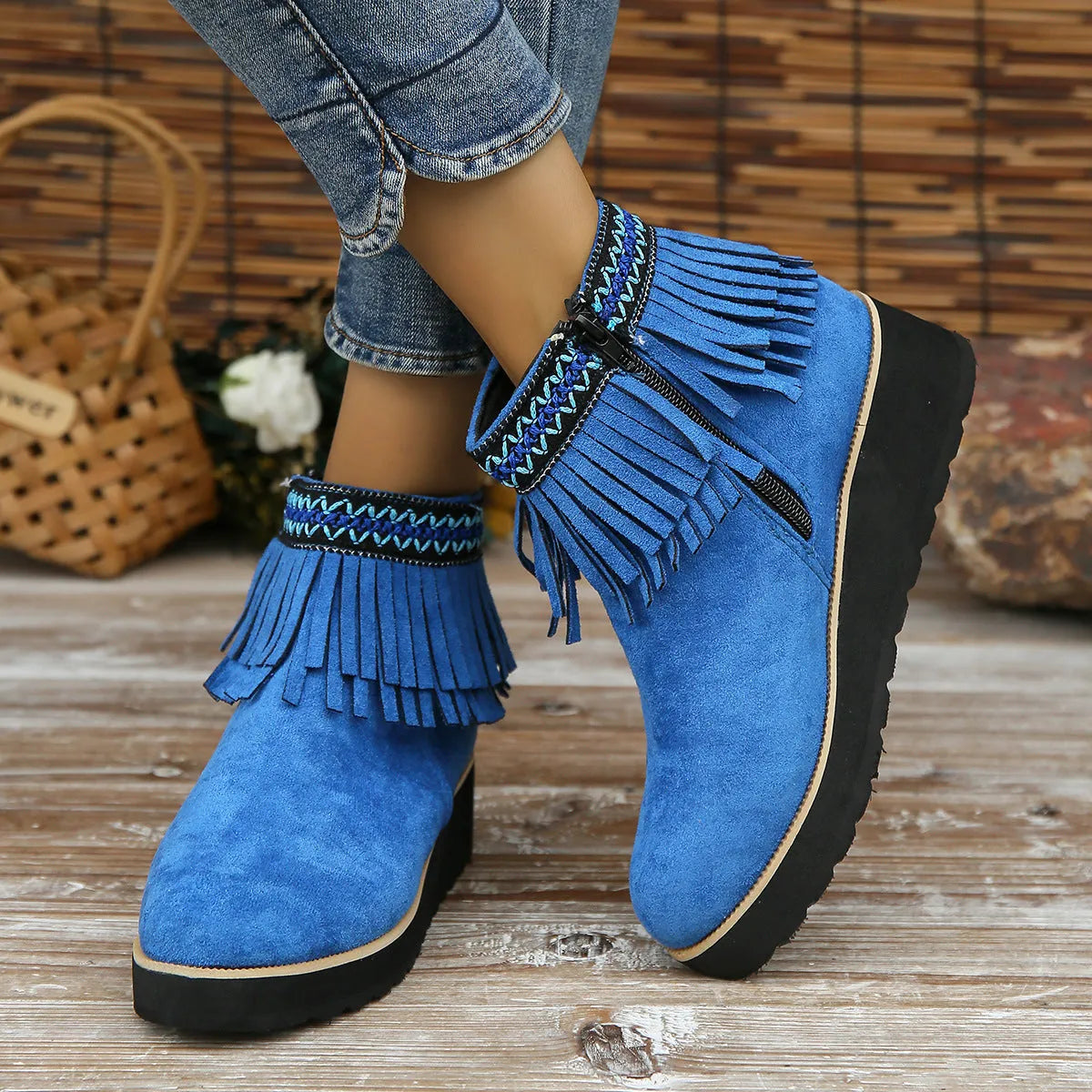 Women's dark brown suede ankle boot with wedge heel, side zipper, and decorative tassel.
