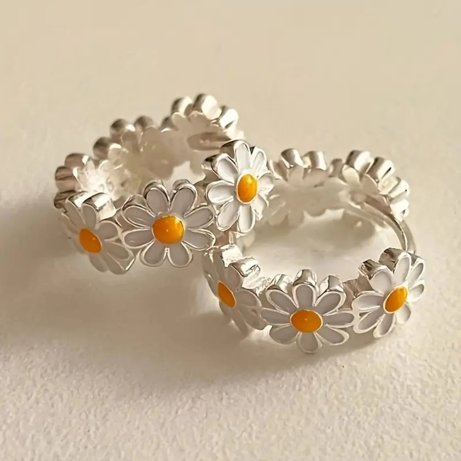 White platinum electroplated daisy flower ring earrings with K-platinum gem accents on a copper base.