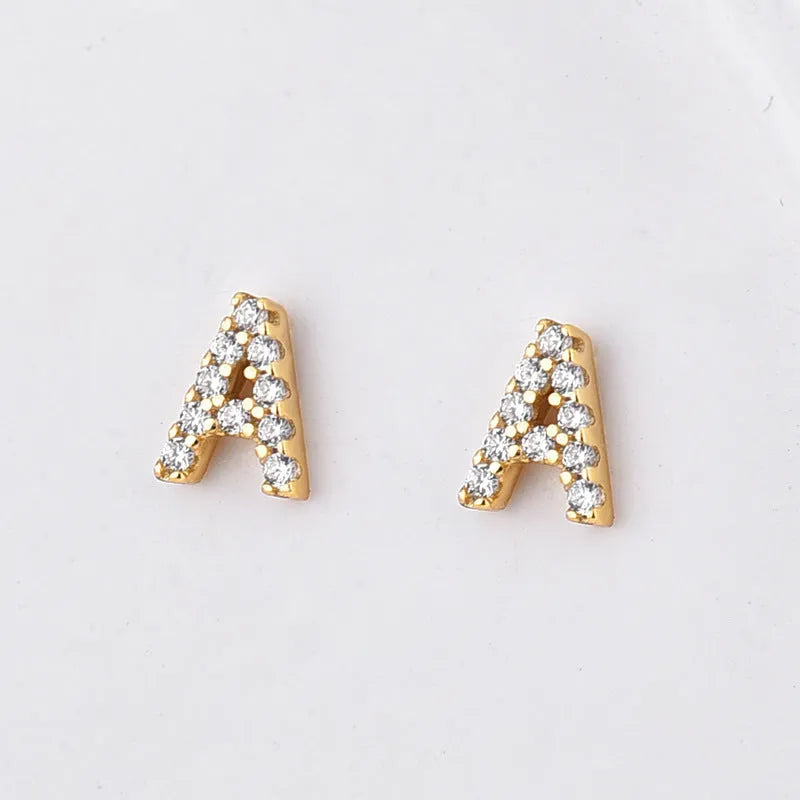 Brass gold plated alphabet earrings showing zircon letter detailing on copper base with gold plating