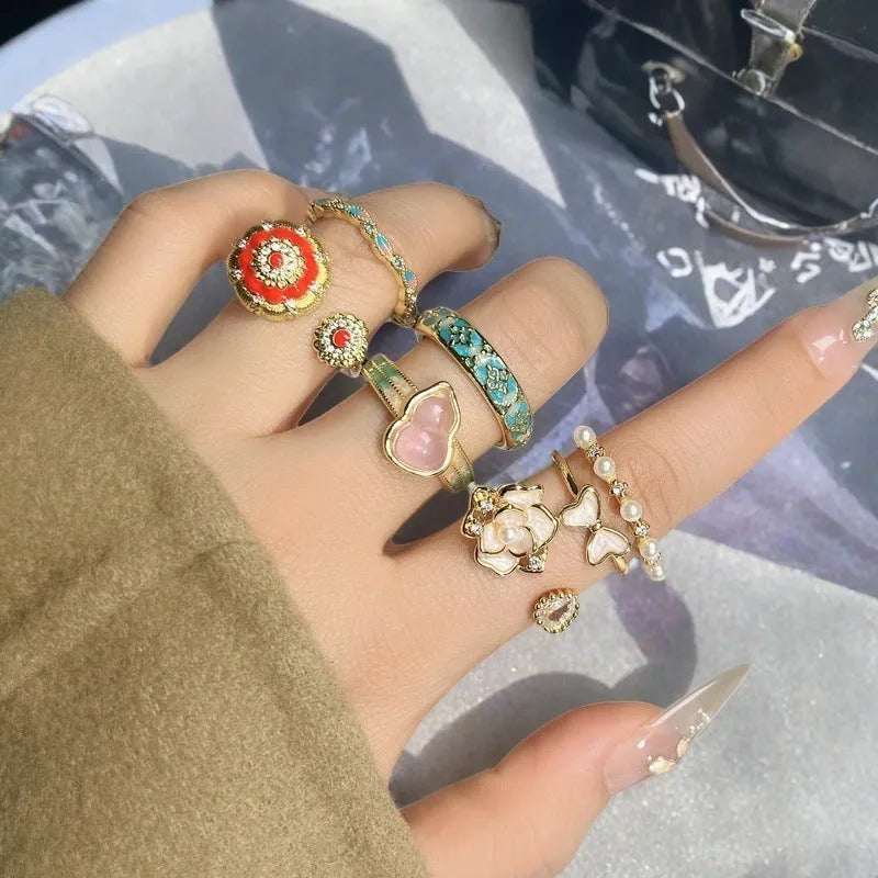 Adjustable Chinese gourd ring with zircon inlay showing floral and bow elements in oil-drip finish
