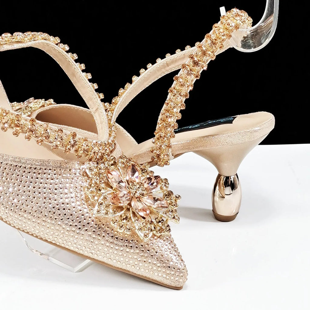 Women's high heel shoes with matching clutch bag featuring decorative flower buckle and ankle chain detail