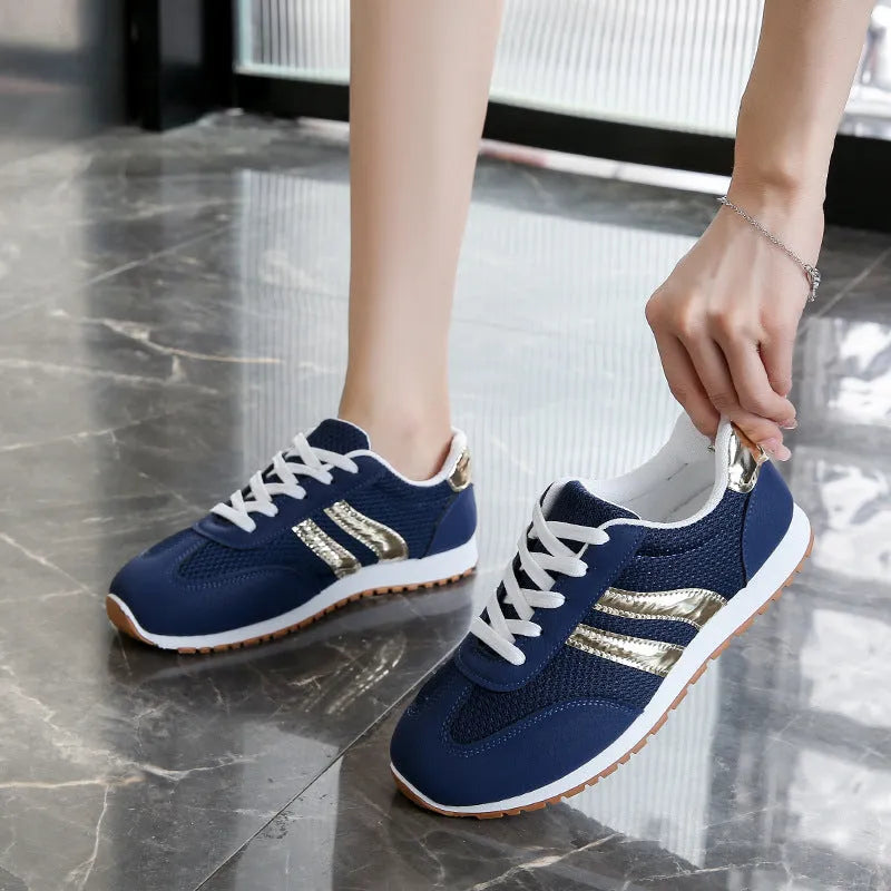 Blue women's casual sports shoes with cross shoulder straps and a lace-up front on a non-slip rubber sole.