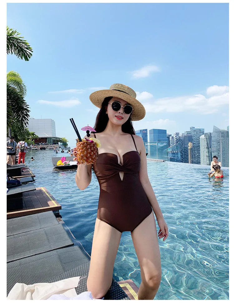Simple solid colour one-piece swimsuit with push-up design and spaghetti straps