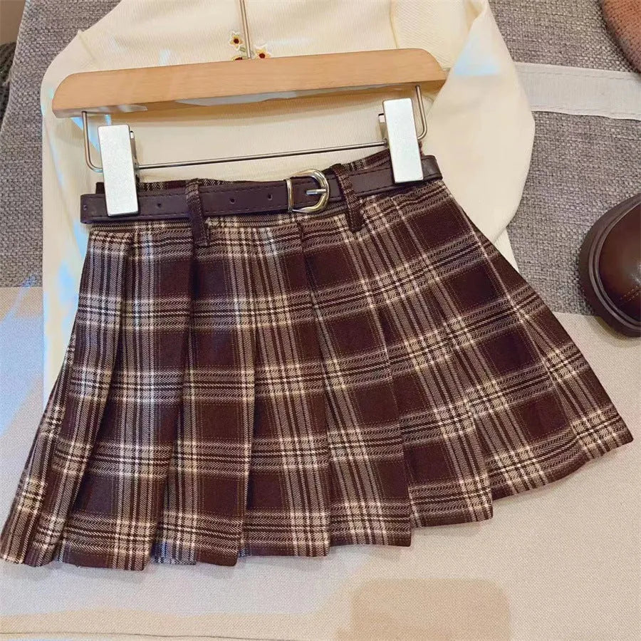 Girls plaid pleated A-line skirt in cotton blend fabric on hanger.