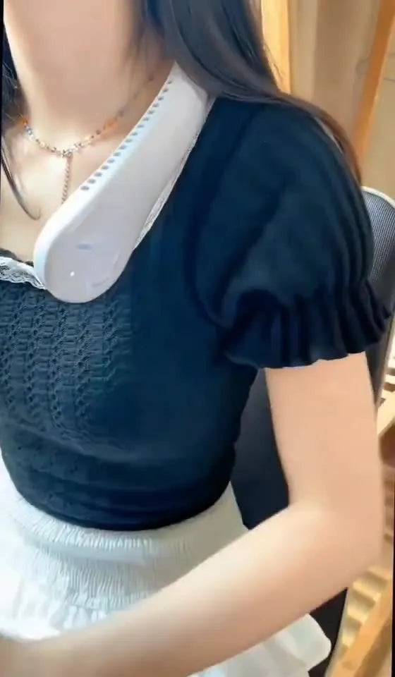 Pink USB rechargeable bladeless neck fan worn around a person's neck.