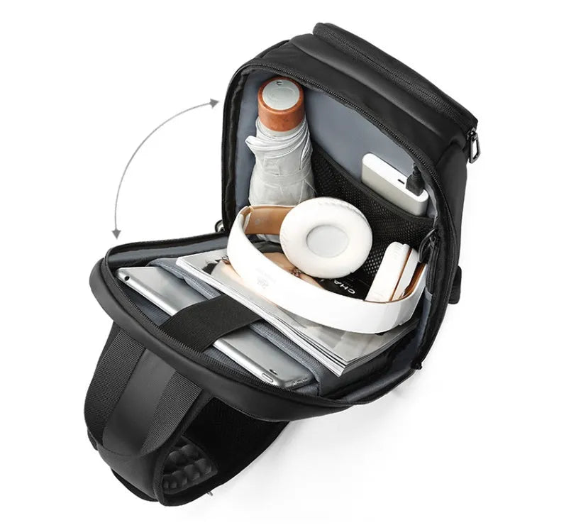 Black PVC outdoor shoulder bag showing computer pocket, air cushion strap, and organisational compartments