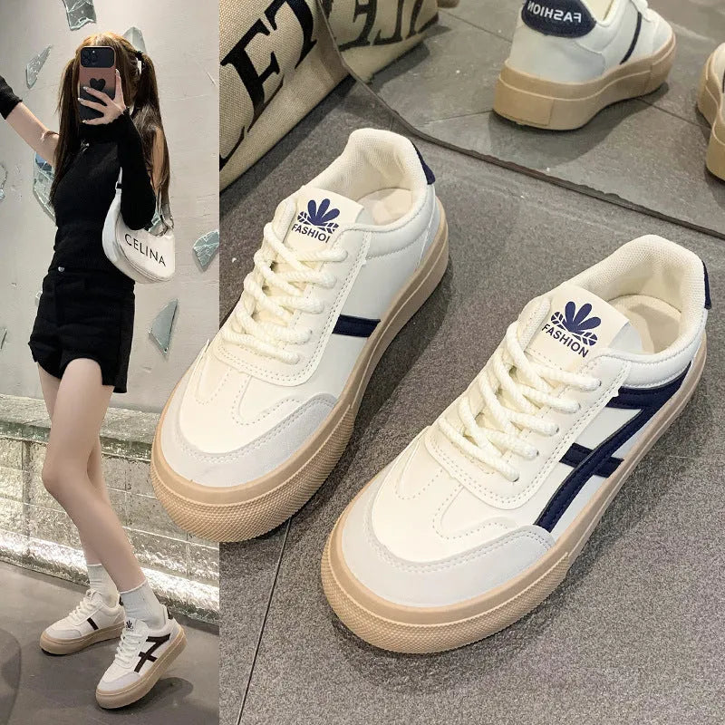 Low top blue board shoes with round toe and flat rubber sole on white background