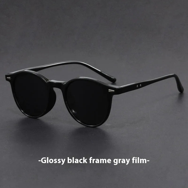 Retro oval sunglasses with ultra-lightweight round frame and polarised grey lenses.