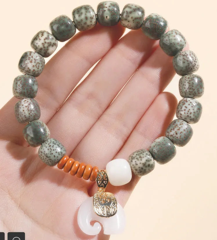 Jade green star moon bodhi bracelet with 10mm geometric beads on white background