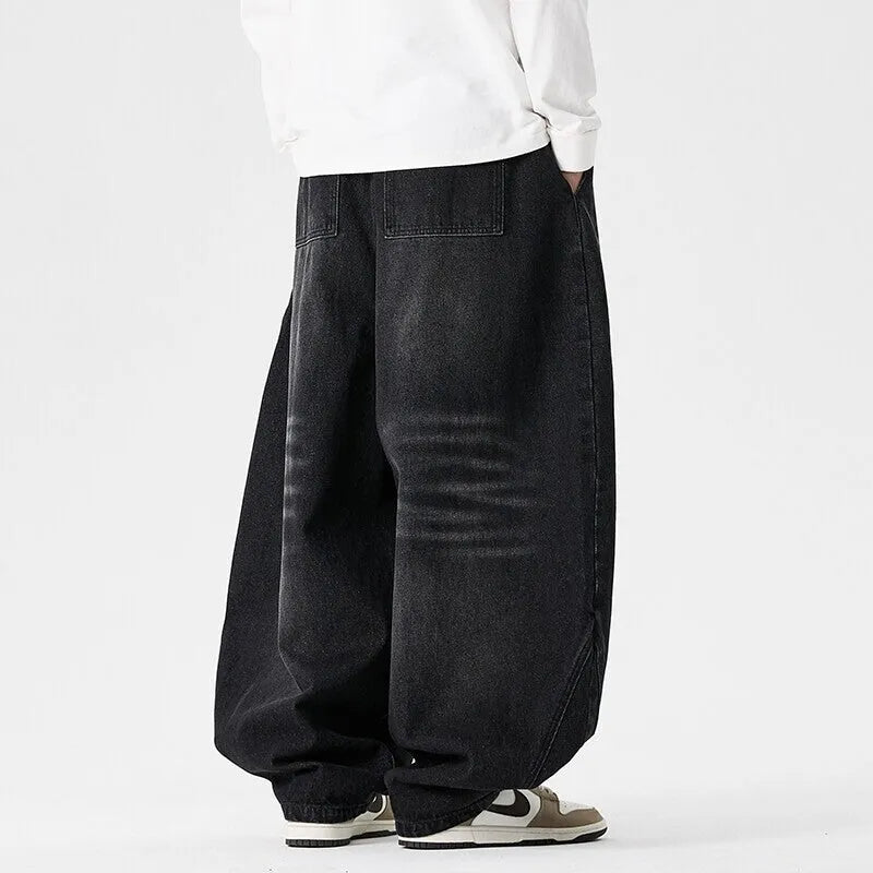 Men's plus size baggy wide leg jeans in light blue denim laid flat