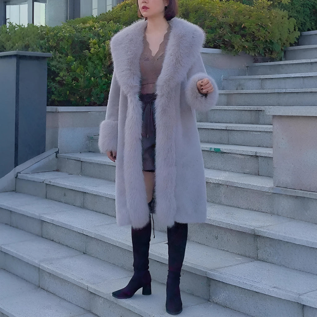 Grey women's leather coat with a faux fur collar and visible plush lining, shown in a mid-length style.