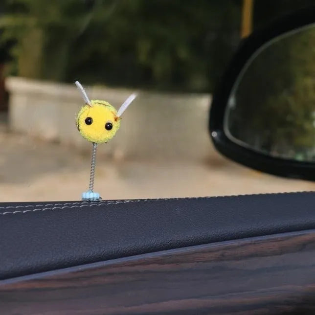 Swing spring bee car decoration made from soft fur ball, showing cartoon bee shape.