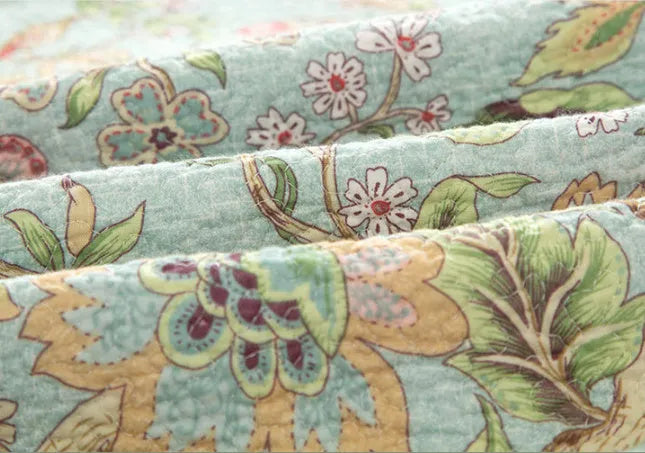 Blue American flower and bird pattern cotton bedspread set with three pieces shown on a bed