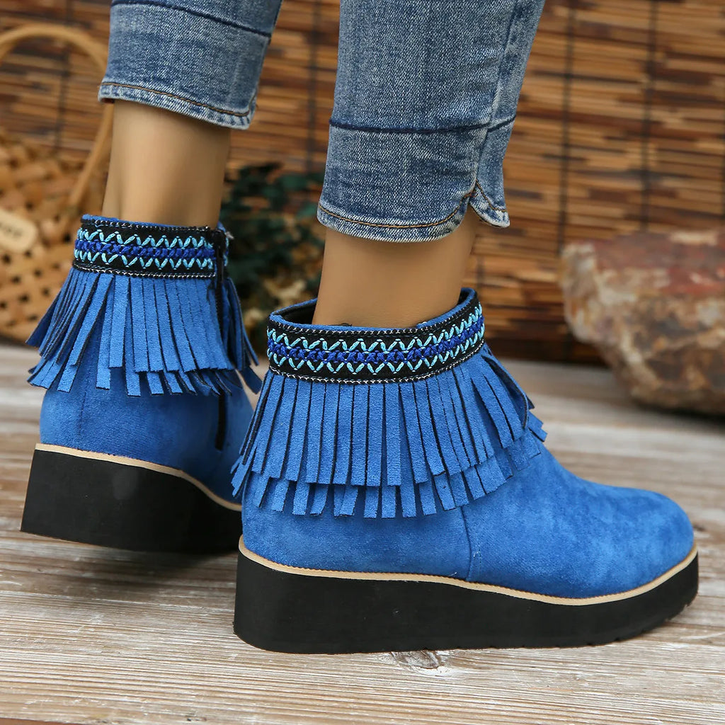 Women's dark brown suede ankle boot with wedge heel, side zipper, and decorative tassel.