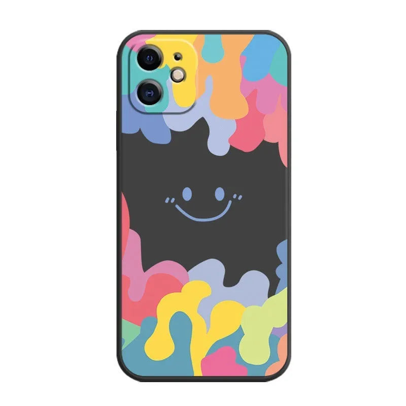 White and black silicone iPhone cases featuring a large rainbow smiley face design, shown with attached lanyards.