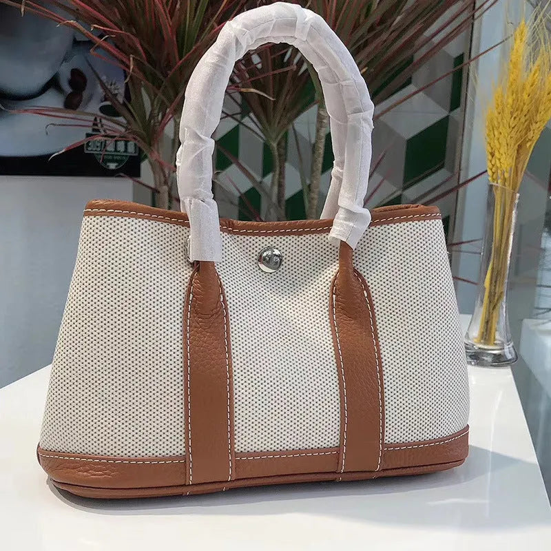 Genuine leather women's crossbody tote bag with canvas texture in bucket shape
