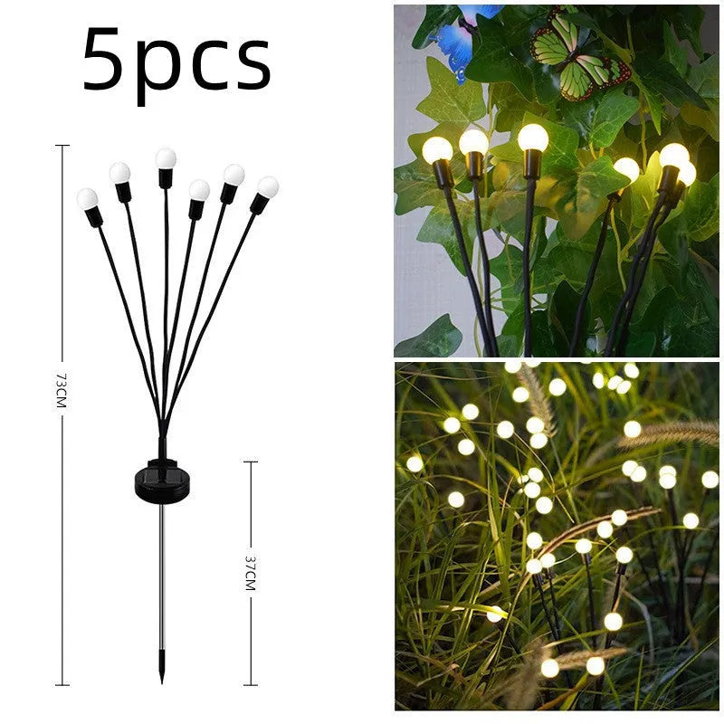 Solar-powered LED firefly lawn light with ground stake inserted in grass