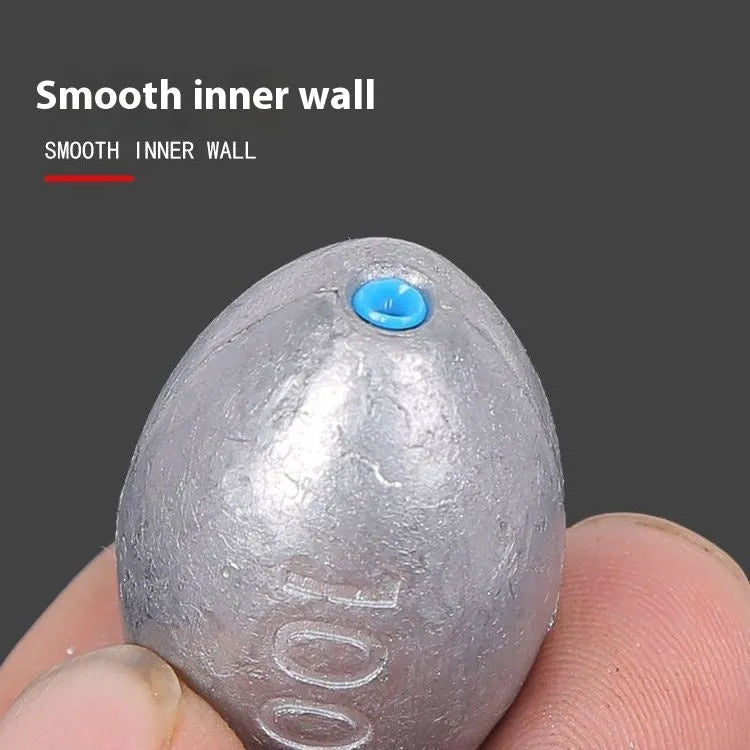Tongxin olive-shaped rugby lead sinker for sea fishing with scale texture, showing plastic core construction.