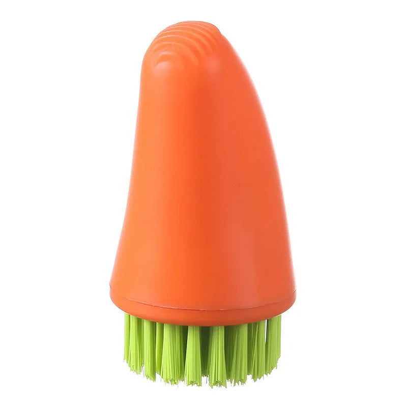 Orange and white carrot-shaped kitchen brush with nylon bristles for scrubbing.