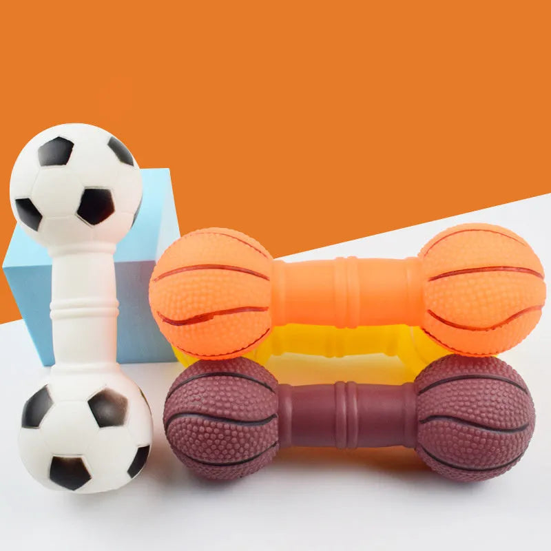 Brown orange white yellow PVC football dumbbell shaped squeaky dog chew toy on a plain background.