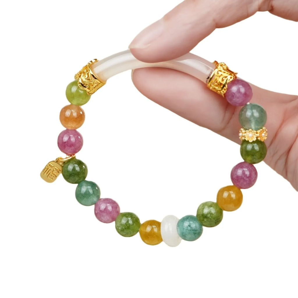 Rainbow coloured tourmaline half bracelet for women on a wrist, showing electroplated finish.