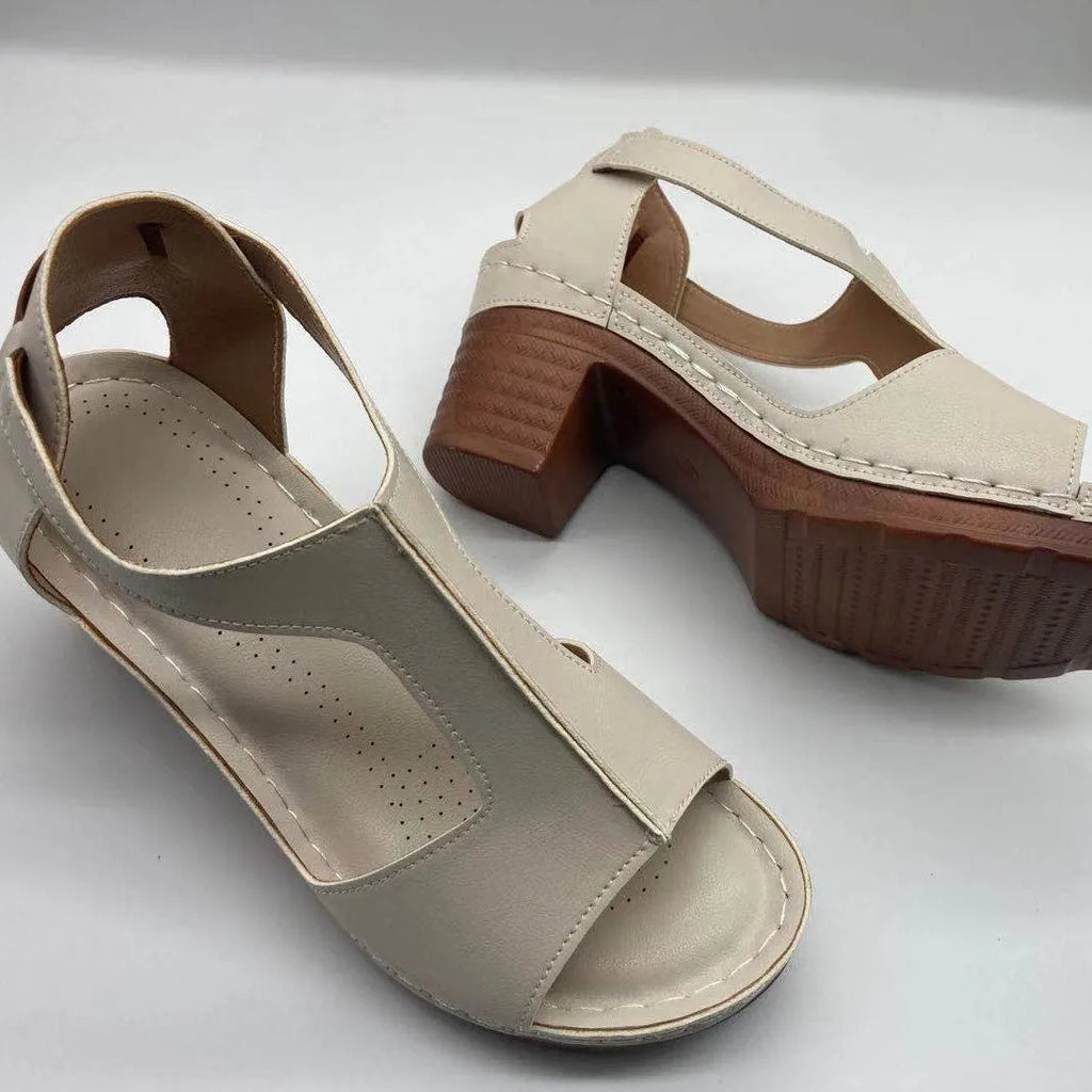 Women's beige peep toe wedge sandals with a buckle strap and low Roman-style heel.