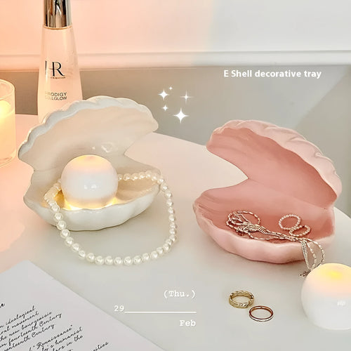 Yellow ceramic ornament tray with a small pink-shell night light placed on it, modern simple style.