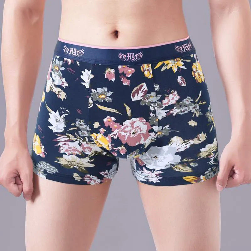 Men's cotton boxer shorts with floral print, showing mid-waist fit and U-shaped convex design.