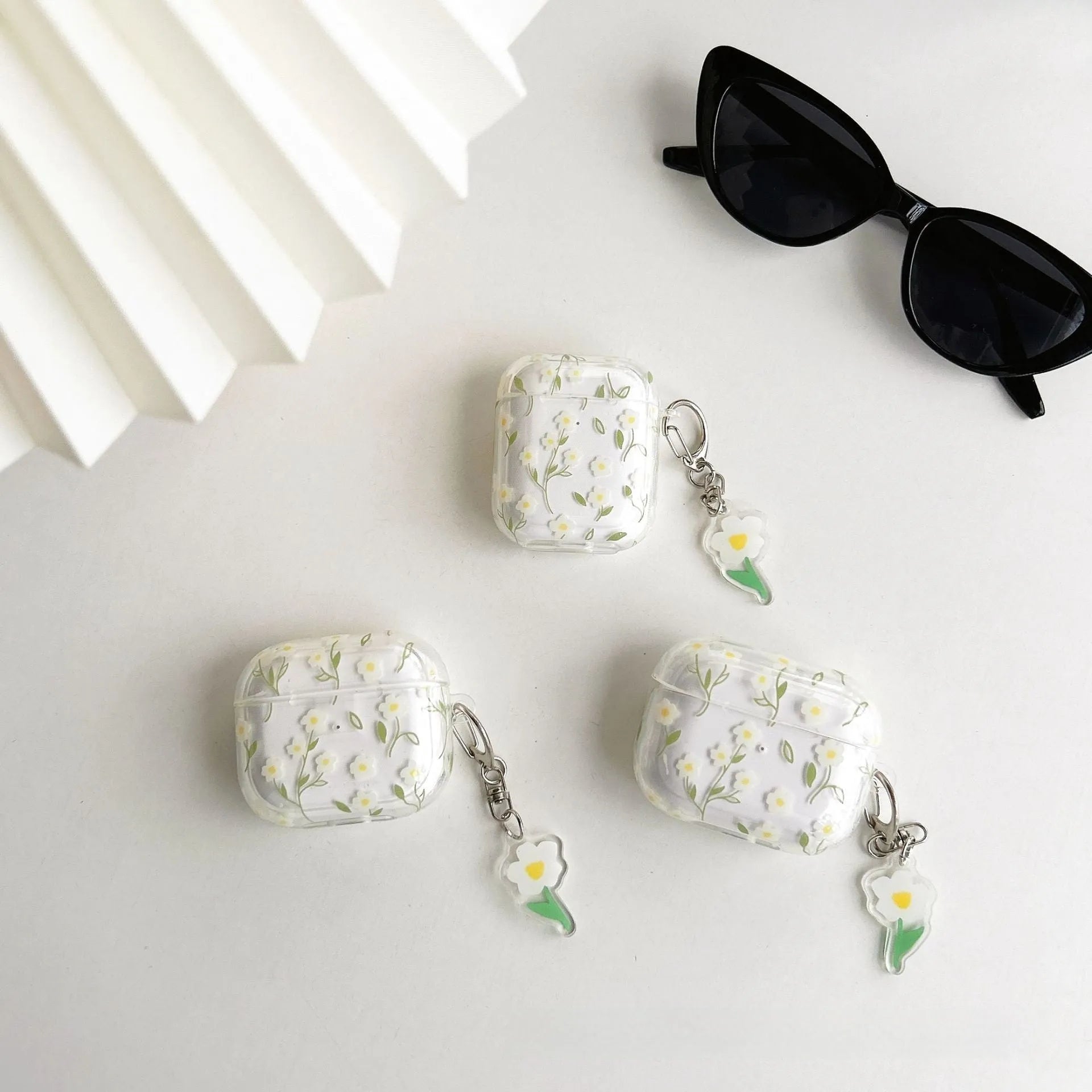 Clear soft TPU protective case for Apple AirPods with white floral oil painting decoration.