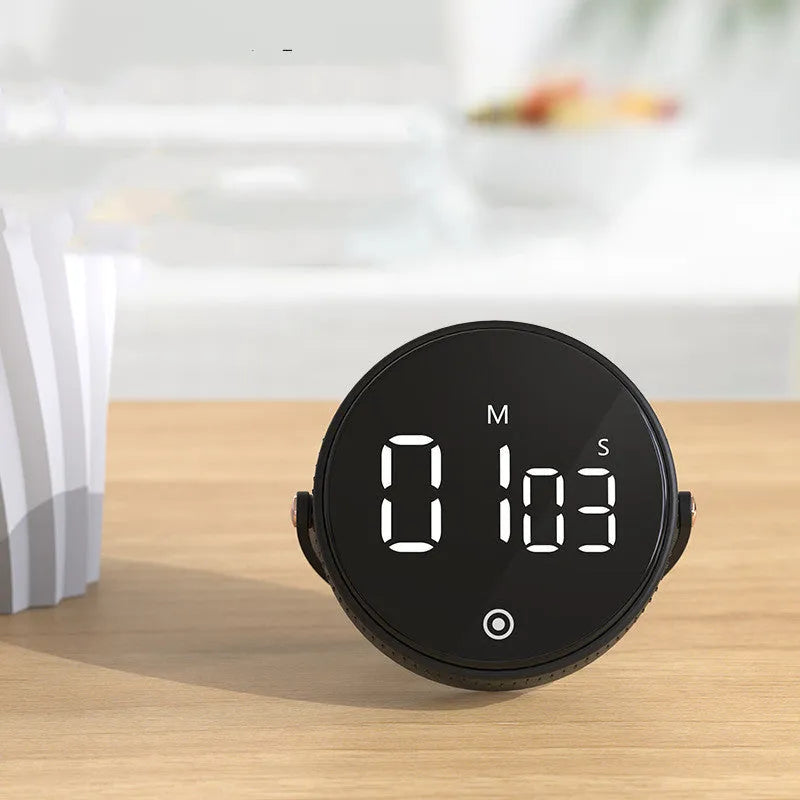 Black digital kitchen timer with rotary dial and LED display showing minutes and seconds