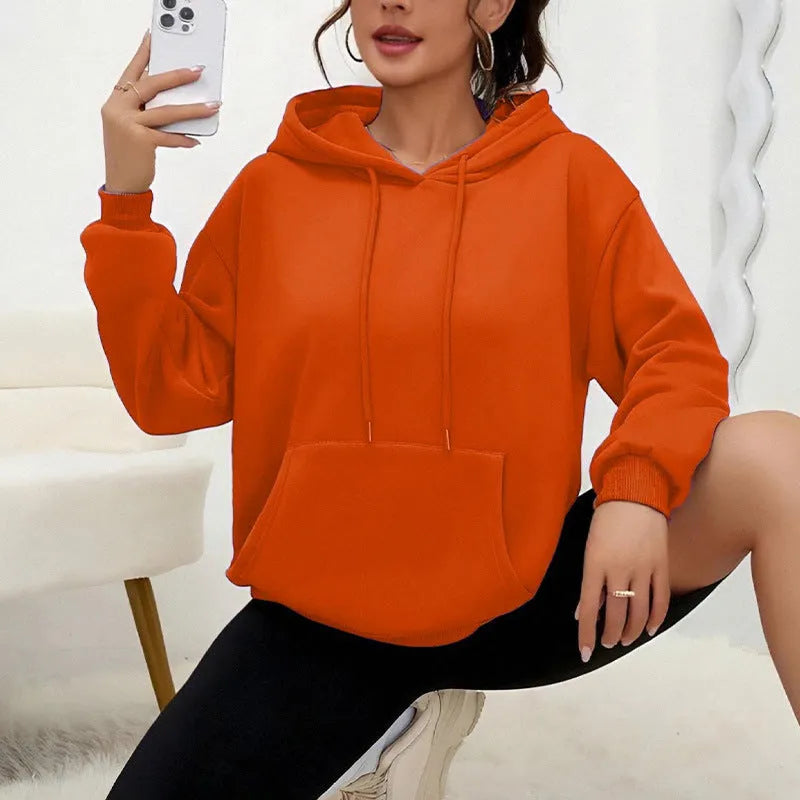 Women's loose fit grey sweatshirt with front drawstring detail and long sleeves on a hanger