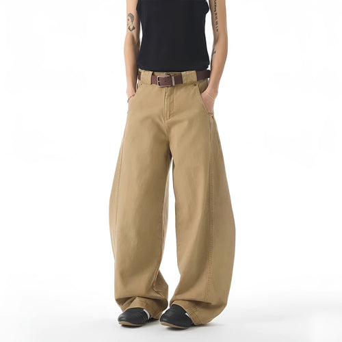 Brown men's loose fit straight leg jeans with a button fly on a mannequin.