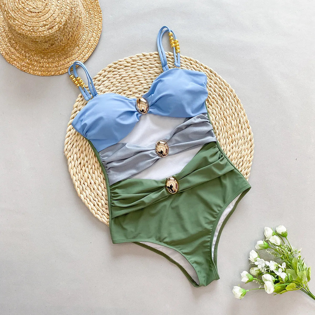 Women's brown one-piece swimsuit with matching beige skirt laid flat