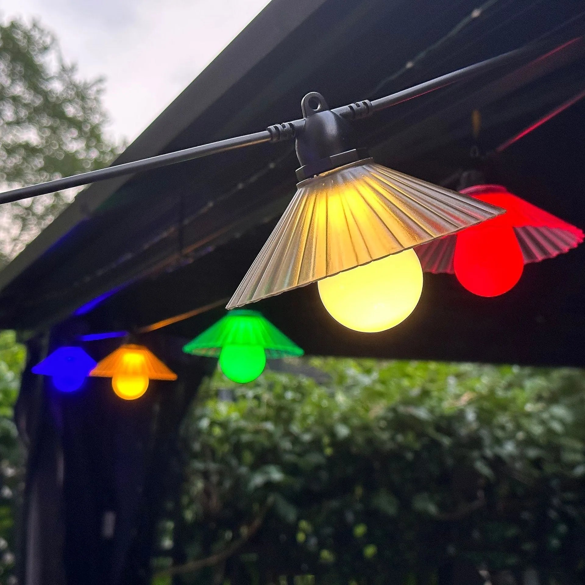 Outdoor LED string lights with flower-shaped bulbs in warm white and multicolour settings.