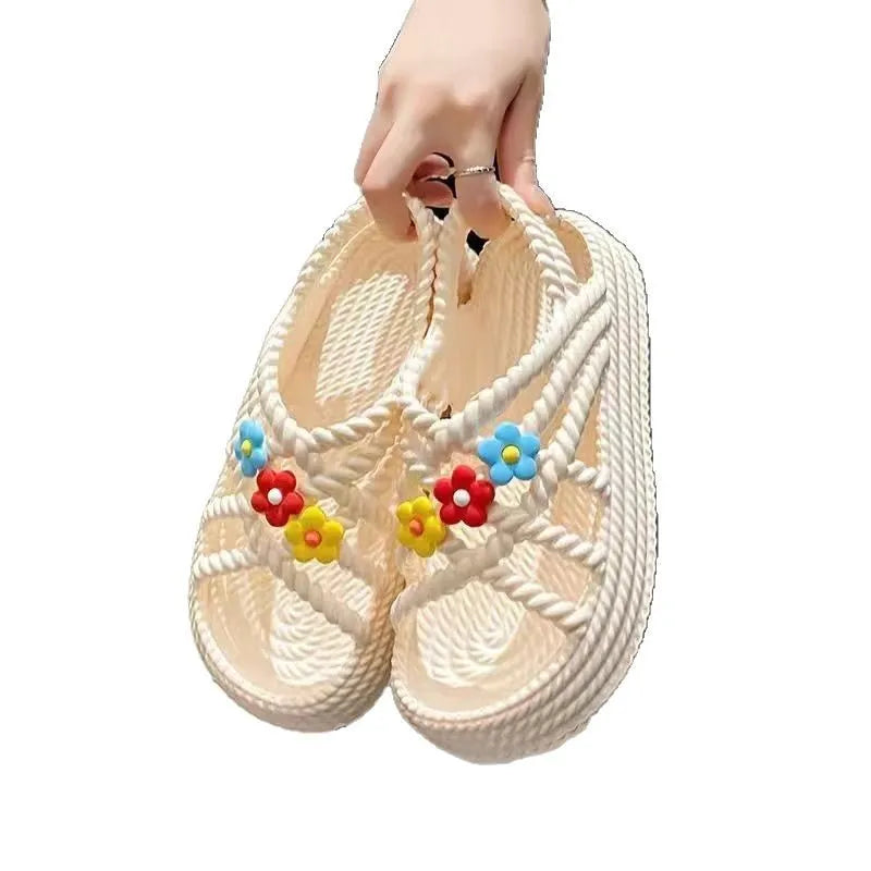 Beige PVC sandals with sunflower pattern and round toe on a non-slip sole.
