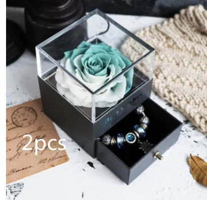 Eternal Flower gift box with preserved roses and carnations inside, measuring 8.5 cm square by 10.5 cm high