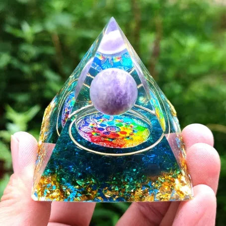 Clear epoxy resin pyramid ornament with embedded coloured crystal gravel inside, measuring 6cm.
