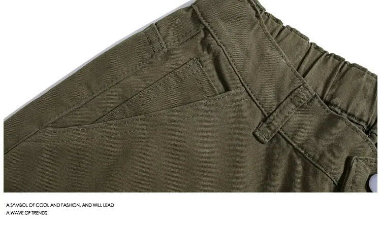 Woman wearing apricot coloured wide-leg cropped casual pants with a mid waist and elasticated band.