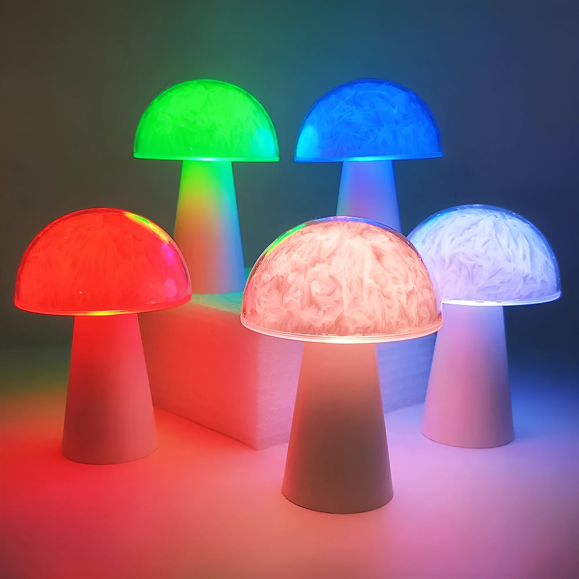 Small white mushroom-shaped decorative night light with RGB colours, remote control, on a wooden table.