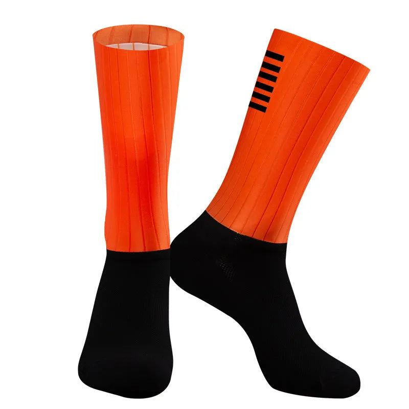 Pair of breathable chemical fibre blend athletic socks for cycling and running, shown in orange colour.