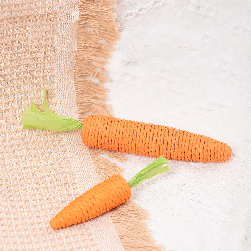 Set of assorted cat toys including fabric carrot bites, crinkly paper toys, ringing stones, feather-like sticks, and chewable tooth grinding sticks.