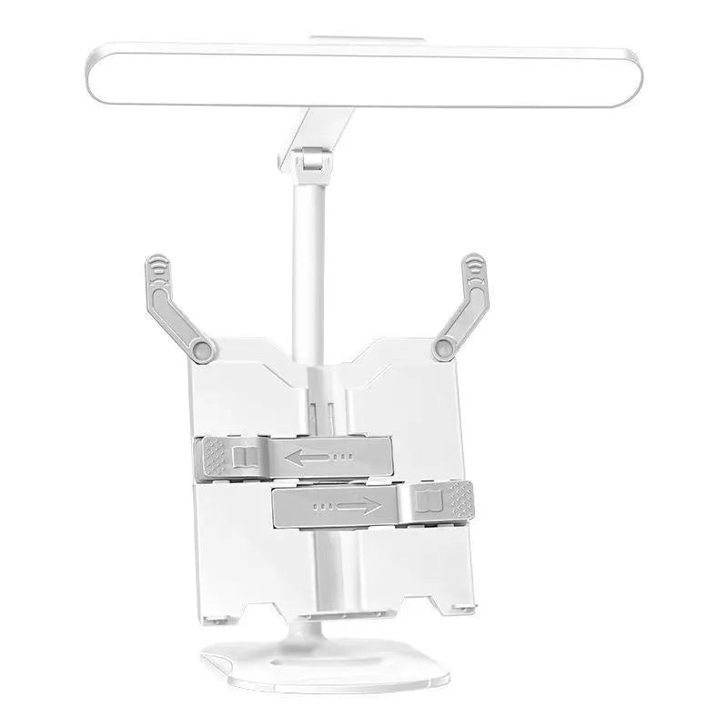 A white adjustable table lamp on a bookshelf with a flexible arm, showing a reading light in use.