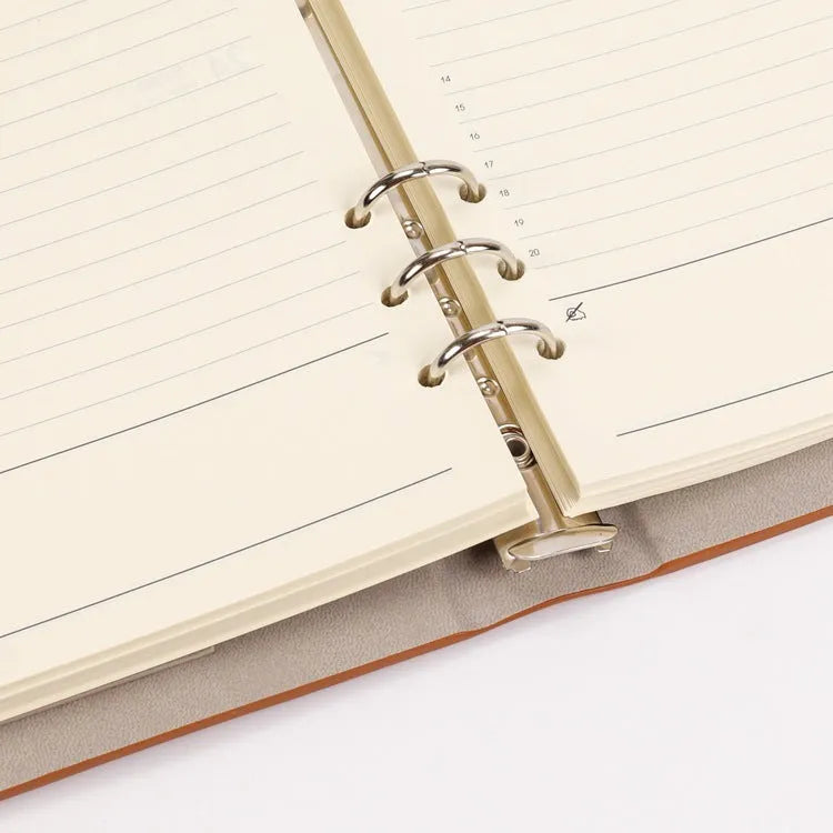 White A5 loose-leaf notebook inner pages with monthly plan layout on a plain background