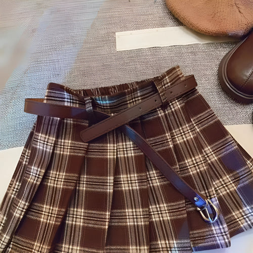 Girls plaid pleated A-line skirt in cotton blend fabric on hanger.