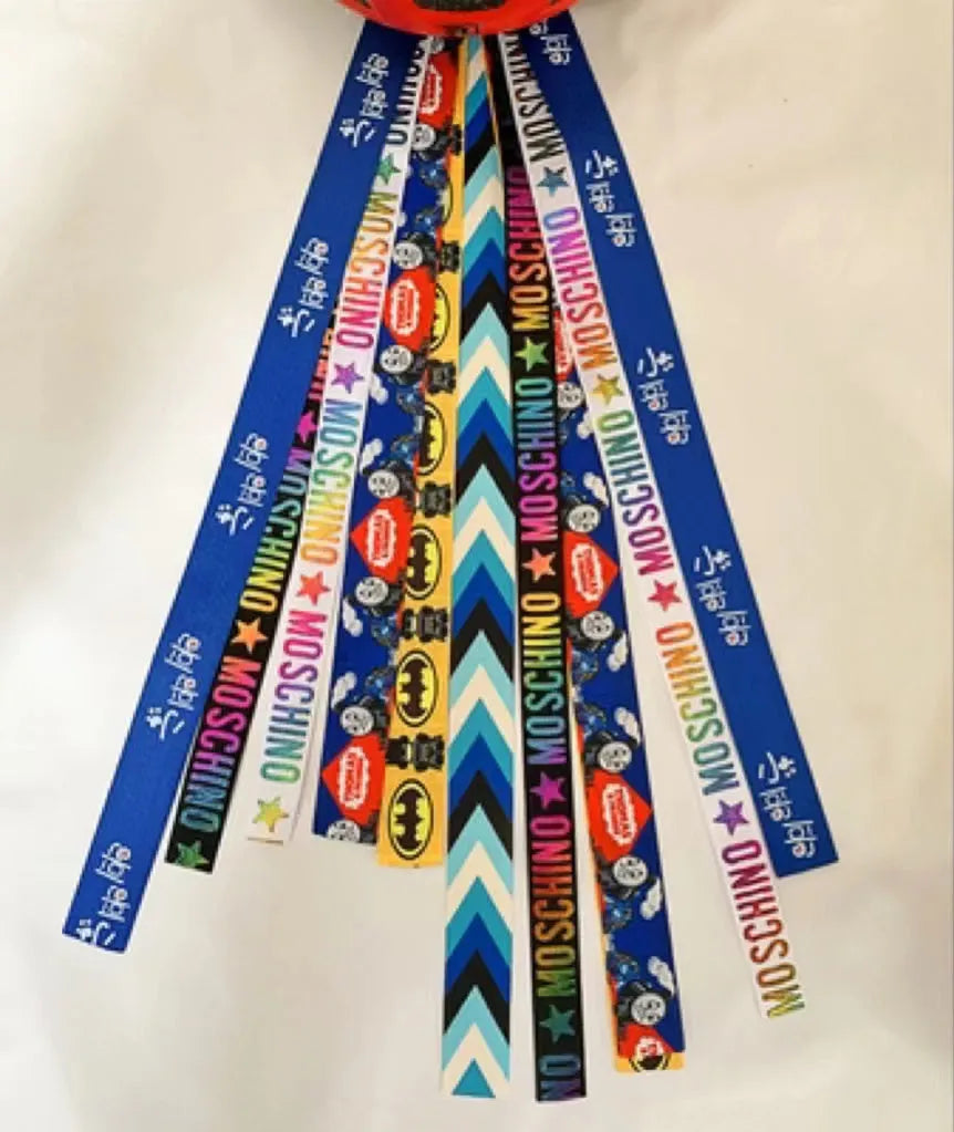 A colourful helmet streamer accessory for children's sports helmets and doll decoration.