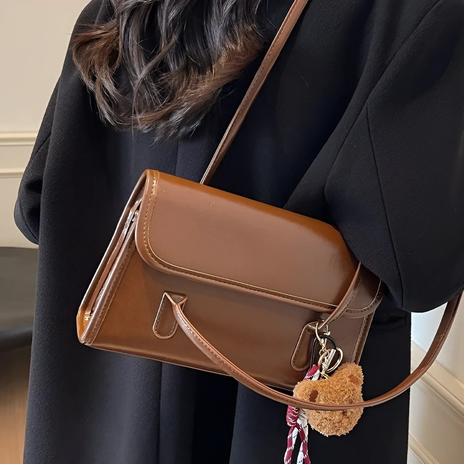 Brown women's PU leather shoulder bag with a square shape, double straps, and a detachable pendant.