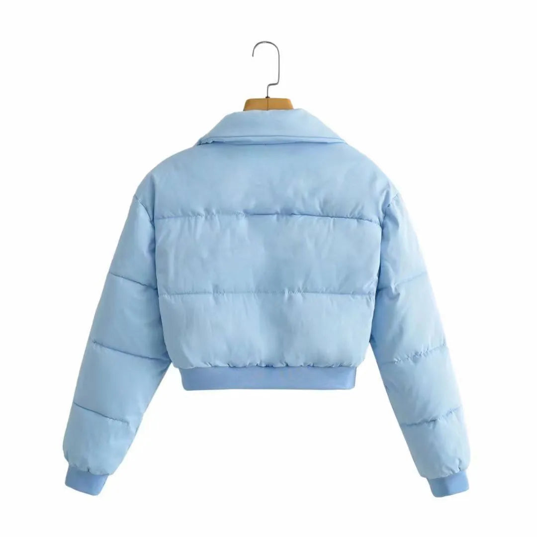 Women's loose fit blue polyester jacket with long sleeves on hanger